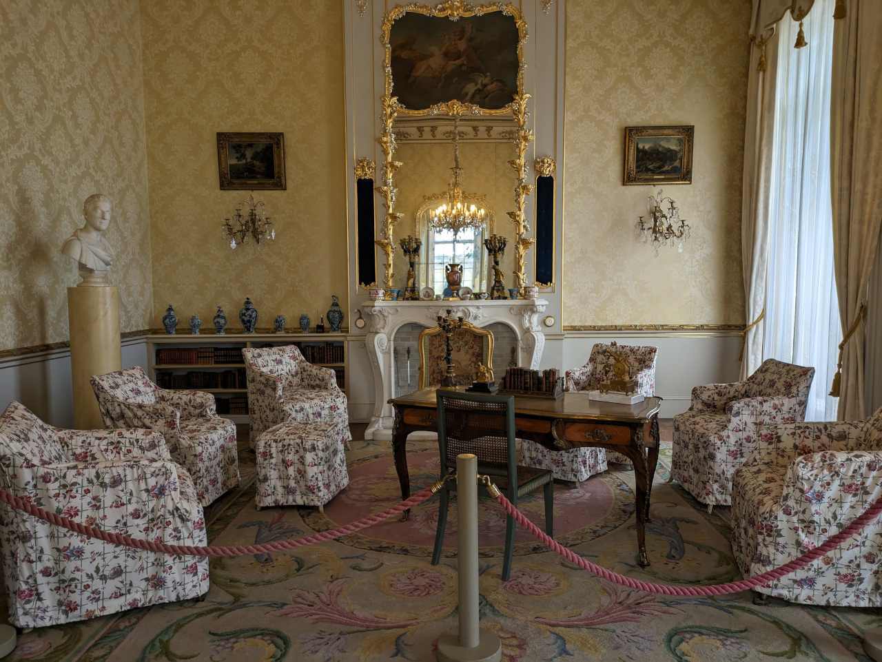 Old furniture with old table, head statue and bookshelf within the Countess sitting room