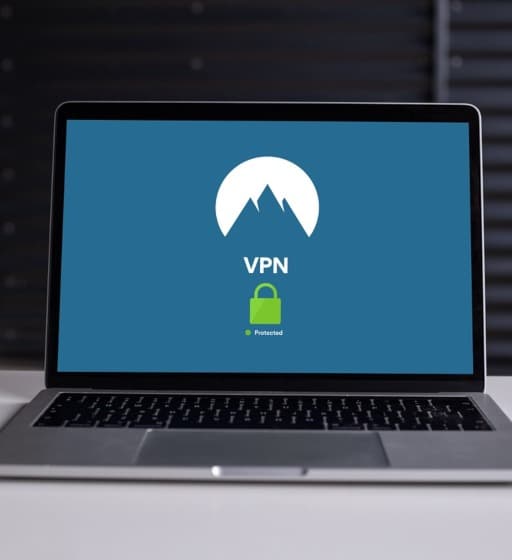 Laptop with blue background with a green padlock belowe text reading VPN above and protected below.